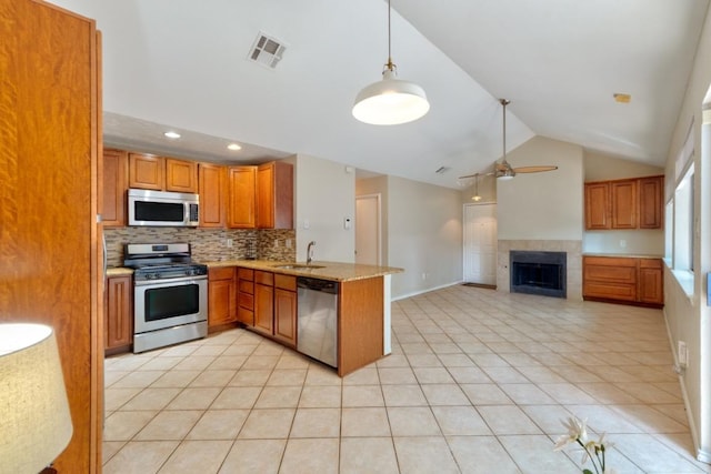 kitchen featuring a ceiling fan, tasteful backsplash, a sink, stainless steel appliances, and visible vents