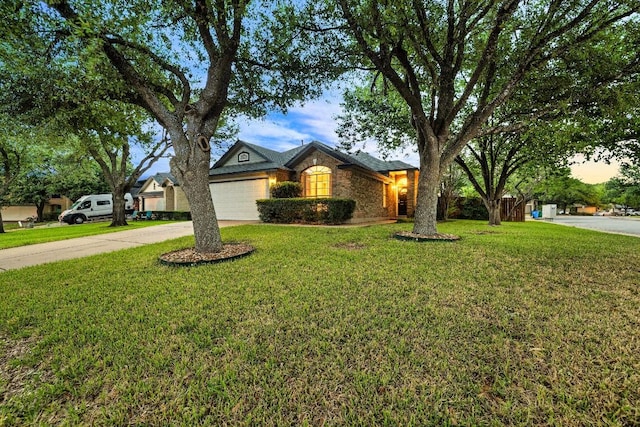 view of front of house with a garage, a front yard, and concrete driveway