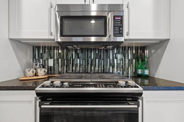 details with stainless steel microwave, tasteful backsplash, range with electric stovetop, and white cabinets