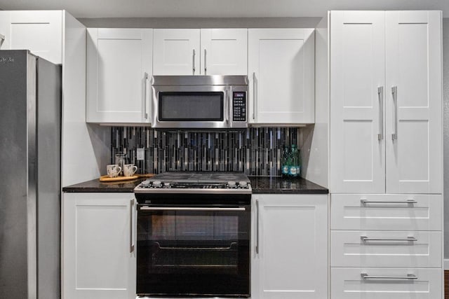 kitchen with backsplash, appliances with stainless steel finishes, and white cabinets