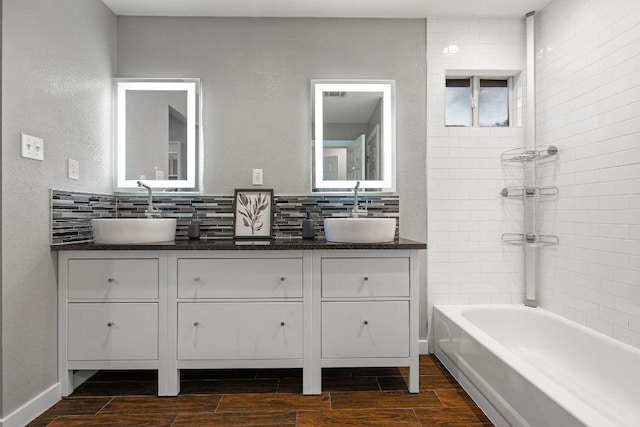 full bathroom with wood finish floors, tasteful backsplash, and vanity