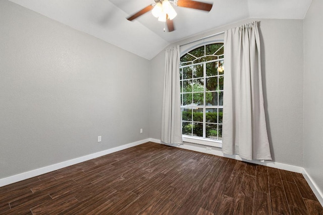 empty room featuring dark wood finished floors, lofted ceiling, baseboards, and ceiling fan
