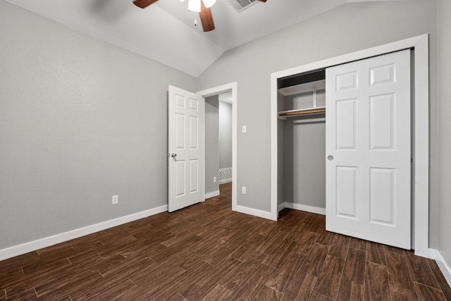 unfurnished bedroom featuring vaulted ceiling, a closet, baseboards, and dark wood-style flooring