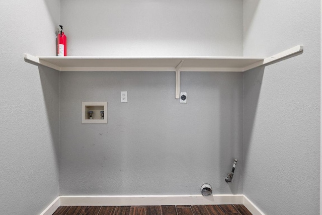 clothes washing area with laundry area, hookup for an electric dryer, dark wood-type flooring, baseboards, and washer hookup