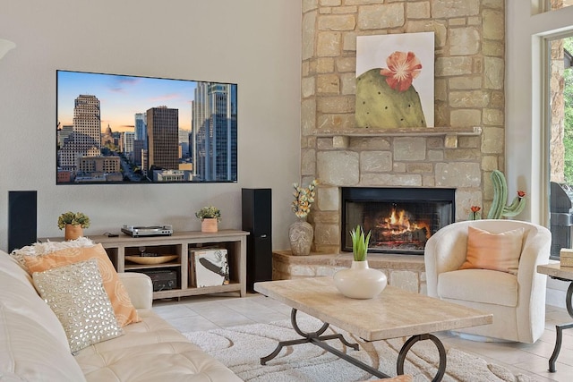 living room with tile patterned floors and a fireplace