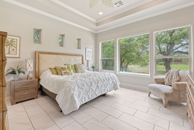 bedroom featuring a raised ceiling, visible vents, crown molding, and baseboards