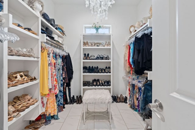 spacious closet with a notable chandelier