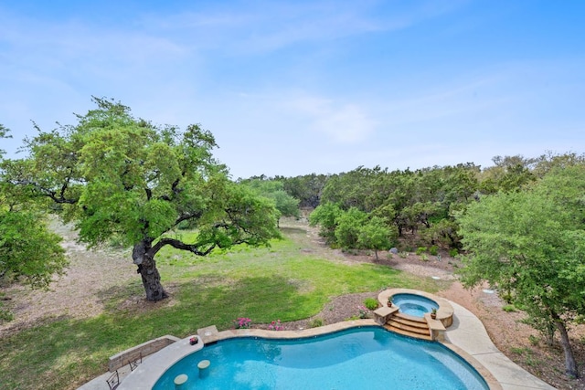 outdoor pool with a yard and an in ground hot tub
