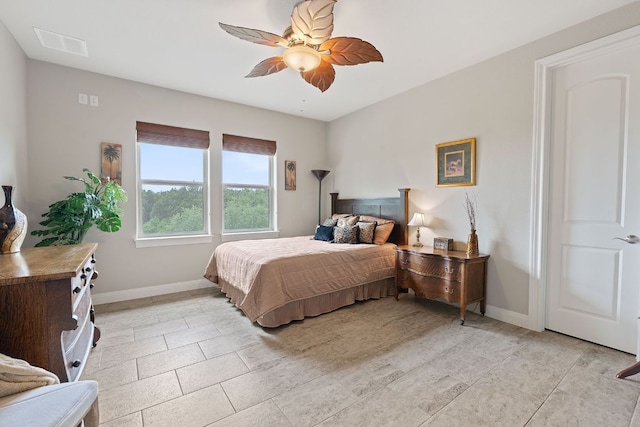 bedroom with baseboards, a ceiling fan, visible vents, and light tile patterned floors