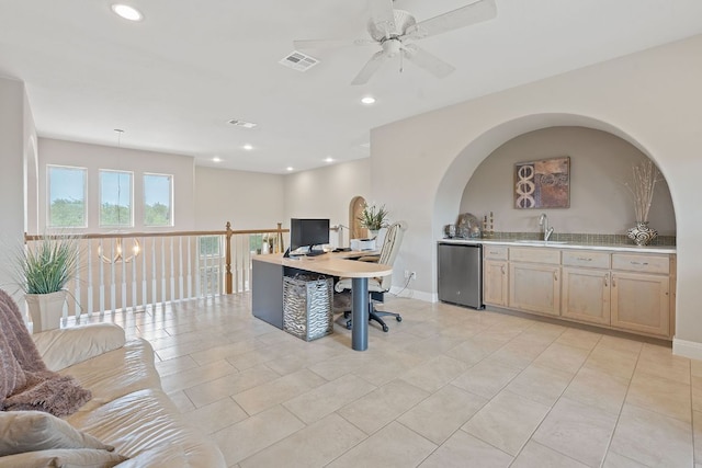 home office with a sink, wet bar, visible vents, ceiling fan with notable chandelier, and light tile patterned floors