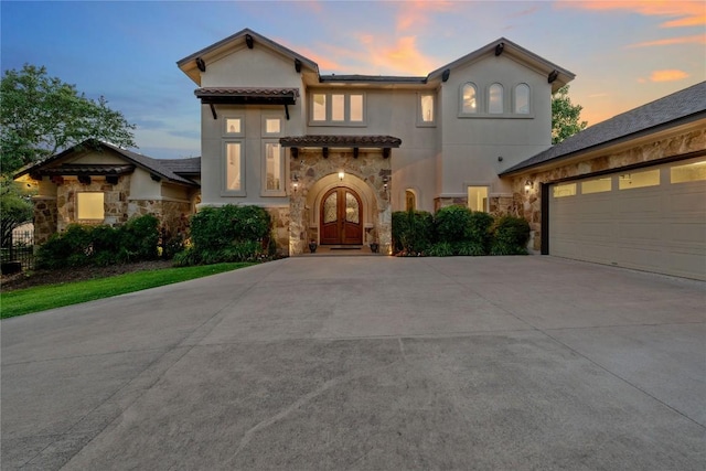 16016 Palomino Ranch Dr, Leander, TX 78641 - mediterranean / spanish home with stone siding, driveway, an attached garage, and stucco siding