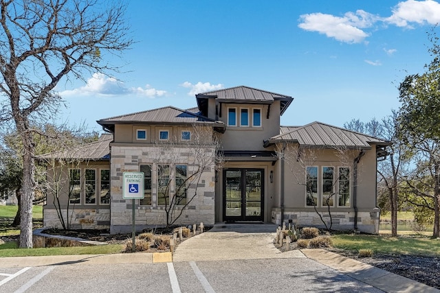 100 Red Rose Dr, Georgetown, TX 78628 - view of front facade featuring stone siding, stucco siding, a standing seam roof, and a metal roof