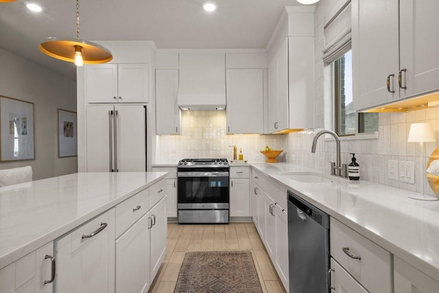 370 Grace Lilly Dr, Buda, TX 78610 - kitchen with stainless steel appliances, custom exhaust hood, a sink, white cabinetry, and recessed lighting