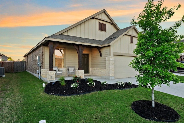 370 Grace Lilly Dr, Buda, TX 78610 - view of front of house featuring board and batten siding, a garage, driveway, covered porch, and central AC unit