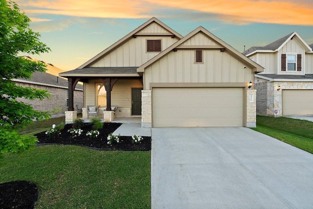 370 Grace Lilly Dr, Buda, TX 78610 - craftsman house featuring board and batten siding, driveway, a garage, and a lawn