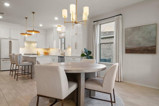 370 Grace Lilly Dr, Buda, TX 78610 - dining room with light wood-type flooring, a chandelier, baseboards, and recessed lighting