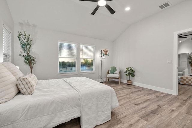 bedroom featuring vaulted ceiling, wood finished floors, visible vents, and baseboards