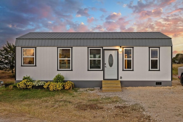 manufactured / mobile home featuring entry steps, crawl space, and metal roof