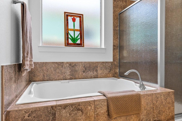 full bathroom featuring a bath, plenty of natural light, and an enclosed shower