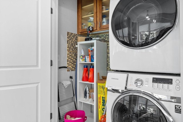 laundry room with stacked washer and dryer and laundry area