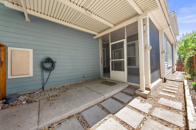 view of patio featuring a sunroom