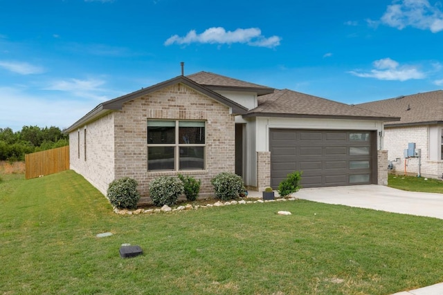 view of front of home featuring fence, concrete driveway, brick siding, a front yard, and a garage