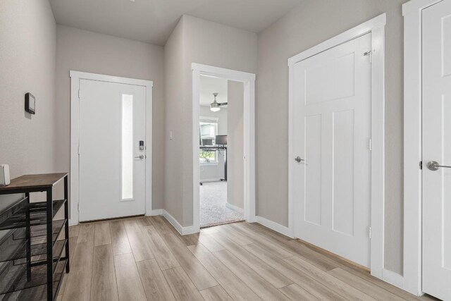 entrance foyer featuring baseboards and light wood finished floors