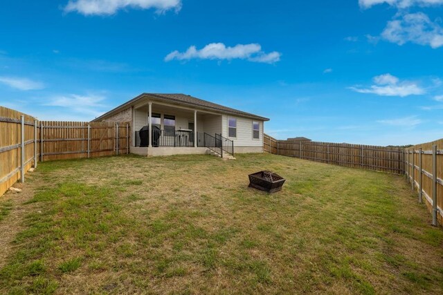 view of yard with a fire pit and a fenced backyard