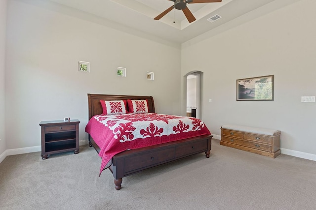 101 Dakota Dr, Georgetown, TX 78633 - bedroom featuring carpet flooring, arched walkways, baseboards, a towering ceiling, and ceiling fan
