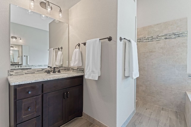 full bathroom with walk in shower, vanity, and backsplash