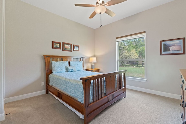 carpeted bedroom featuring baseboards and ceiling fan