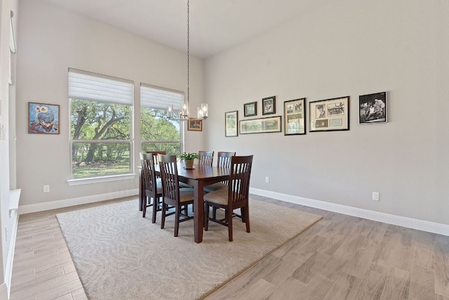 101 Dakota Dr, Georgetown, TX 78633 - dining area with a chandelier, baseboards, and wood finished floors