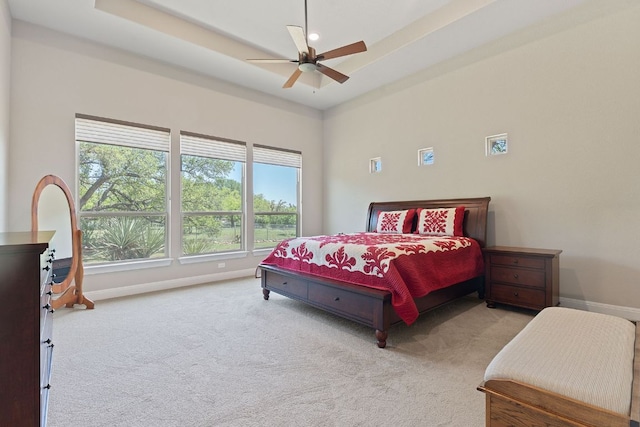 carpeted bedroom featuring baseboards and ceiling fan