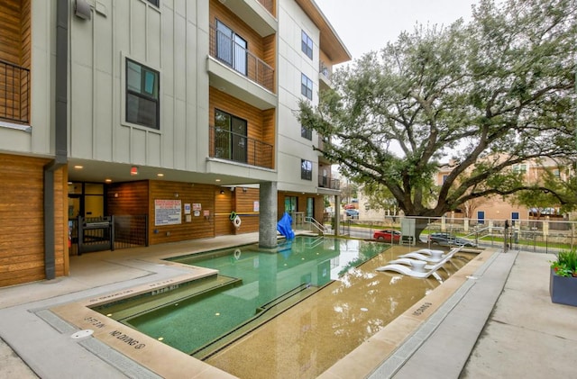 view of pool featuring fence
