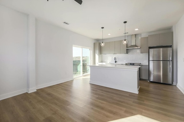 2500 Longview St Unit 501, Austin, TX 78705 - kitchen featuring freestanding refrigerator, wall chimney exhaust hood, gray cabinets, tasteful backsplash, and recessed lighting