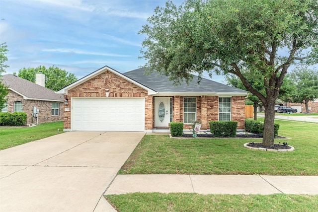 129 Aguilar Dr, Hutto, TX 78634 - single story home with a garage, concrete driveway, a front yard, and brick siding