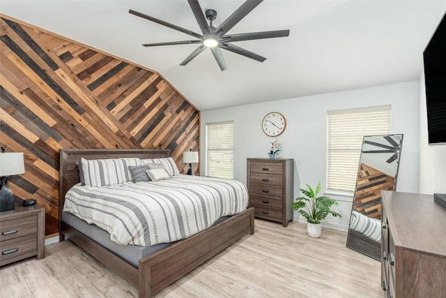 129 Aguilar Dr, Hutto, TX 78634 - bedroom with vaulted ceiling, wood walls, light wood-style flooring, and ceiling fan