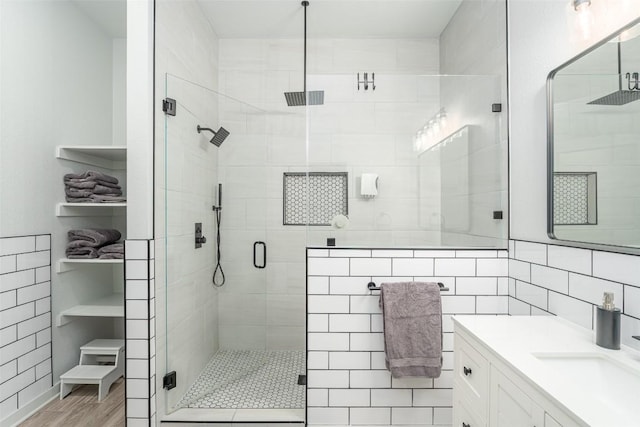 129 Aguilar Dr, Hutto, TX 78634 - bathroom with vanity, a shower stall, and wood finished floors