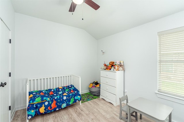 129 Aguilar Dr, Hutto, TX 78634 - bedroom with wood finished floors, multiple windows, vaulted ceiling, and a ceiling fan