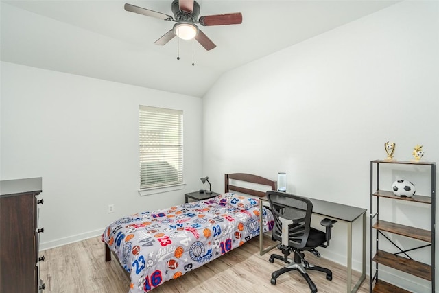 129 Aguilar Dr, Hutto, TX 78634 - bedroom with lofted ceiling, wood finished floors, a desk, and a ceiling fan