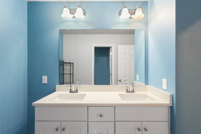 345 Coba St, Leander, TX 78641 - full bathroom featuring double vanity and a textured wall