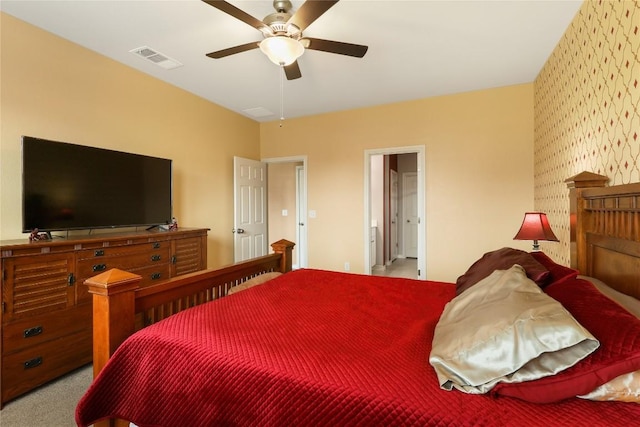 345 Coba St, Leander, TX 78641 - carpeted bedroom with wallpapered walls, a ceiling fan, and ensuite bath