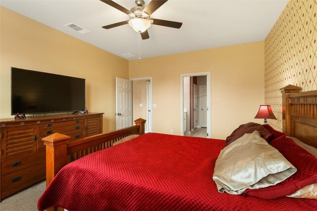 345 Coba St, Leander, TX 78641 - bedroom with wallpapered walls, carpet floors, ceiling fan, and connected bathroom