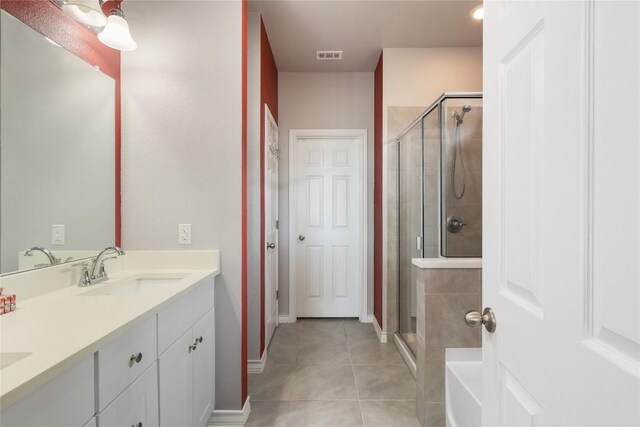 345 Coba St, Leander, TX 78641 - full bath featuring tile patterned floors, a shower stall, and double vanity