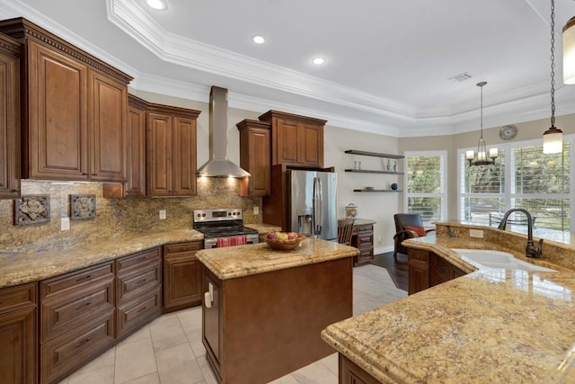 1164 Fairway Dr, Canyon Lake, TX 78133 - kitchen with wall chimney exhaust hood, a tray ceiling, a sink, an island with sink, and appliances with stainless steel finishes