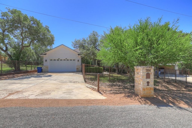 1164 Fairway Dr, Canyon Lake, TX 78133 - view of front facade featuring a garage, concrete driveway, and fence