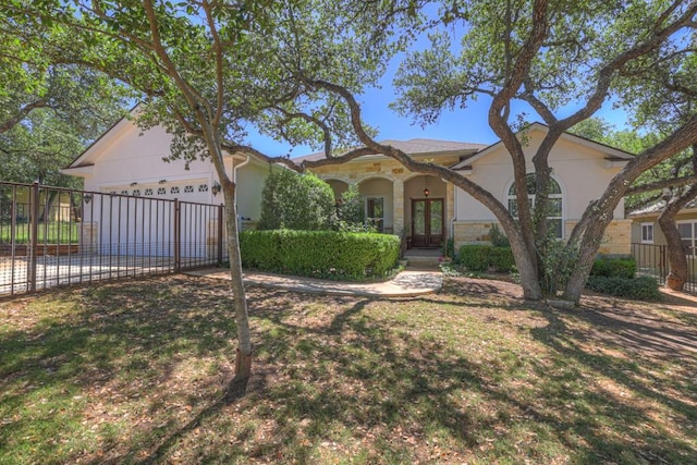 1164 Fairway Dr, Canyon Lake, TX 78133 - mediterranean / spanish-style house with stucco siding, fence, driveway, and french doors
