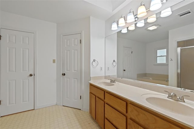 104 Tonkawa Cv, Kyle, TX 78640 - full bathroom with tile patterned floors, a garden tub, a sink, and a shower stall