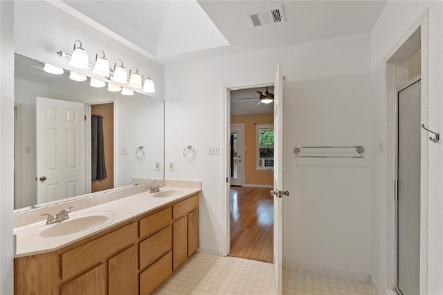 104 Tonkawa Cv, Kyle, TX 78640 - bathroom with double vanity, visible vents, tile patterned floors, and a sink