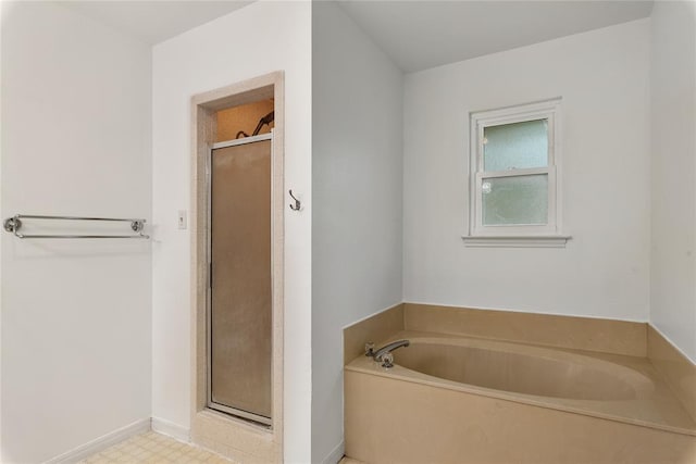 104 Tonkawa Cv, Kyle, TX 78640 - full bathroom with a shower stall, a garden tub, and baseboards